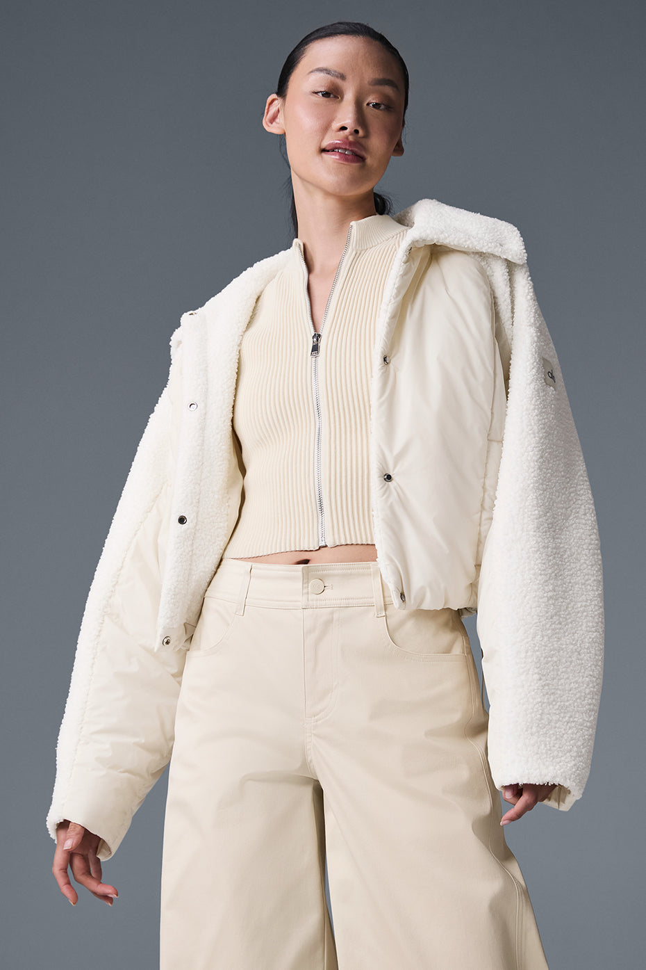 Close-up of the sherpa jacket's plush collar and ivory quilted fabric