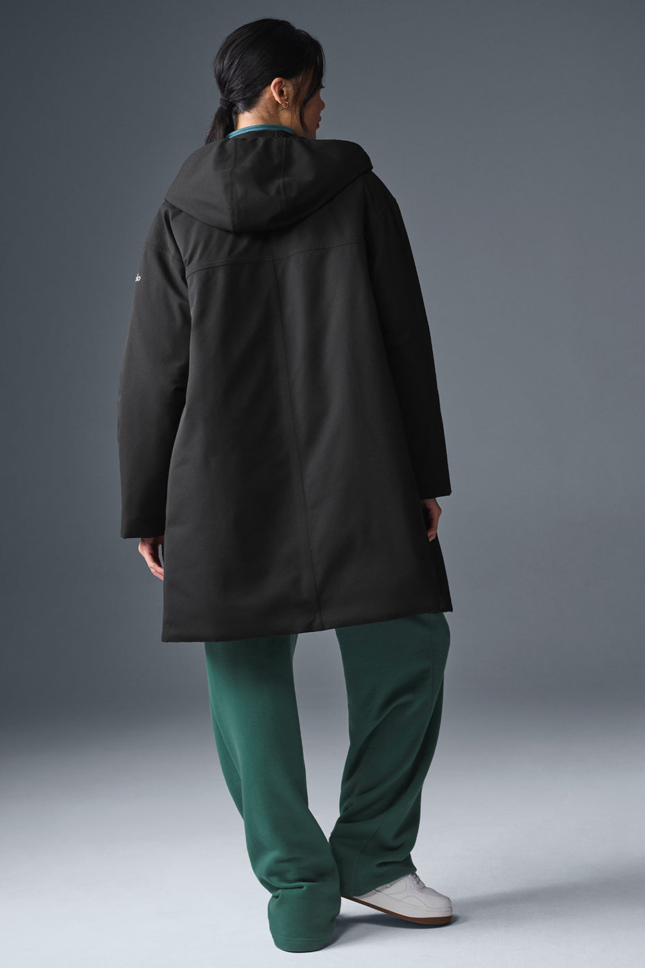 Back view of the black puffer coat, demonstrating its lightweight and warm interior.