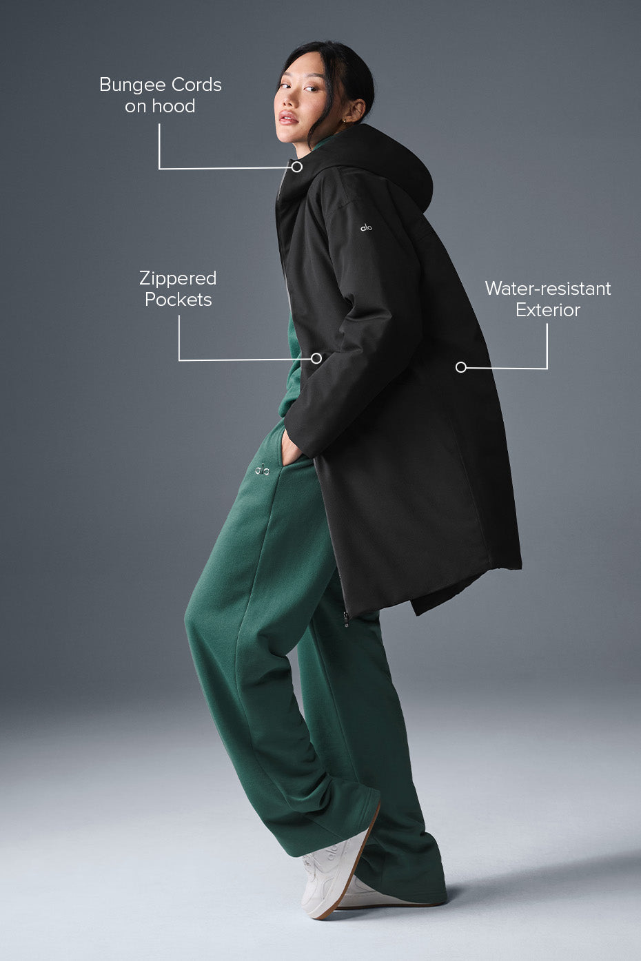 Side view of the womens long puffer coat, highlighting its water-resistant features.