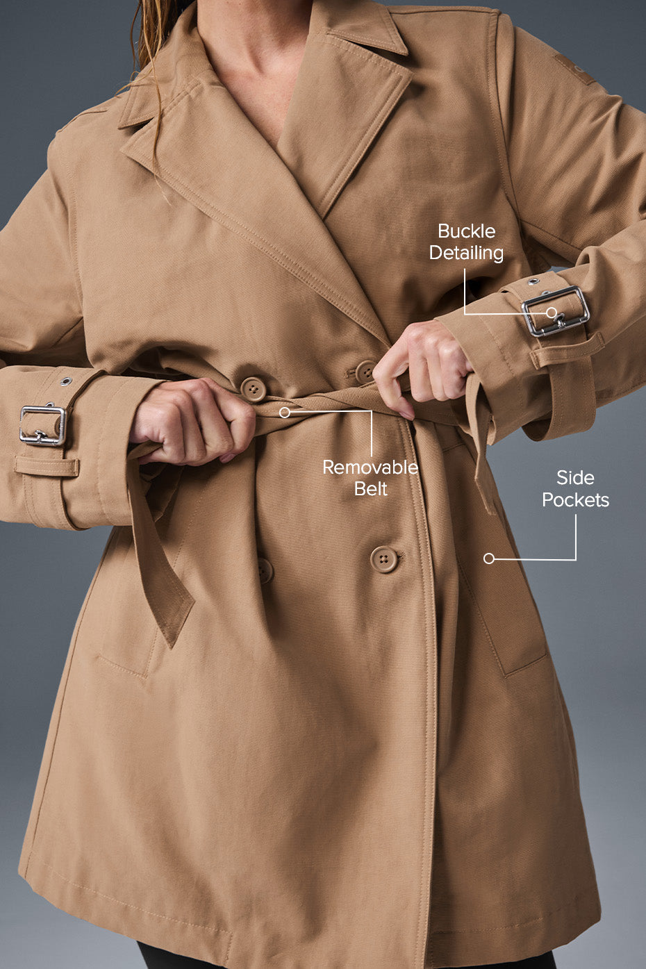 Model wearing the trench coat open over a turtleneck and tailored pants