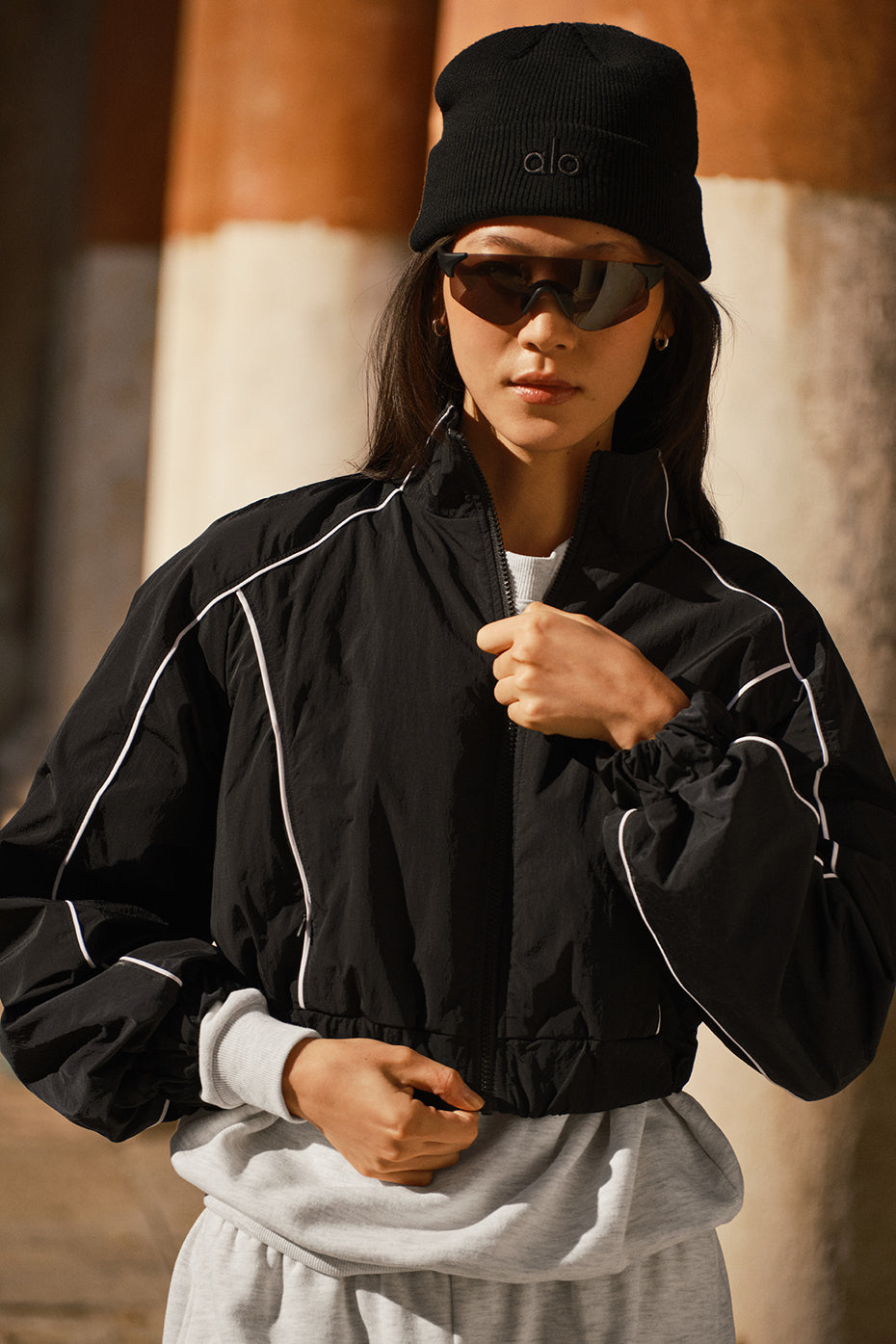 Front view of the Motivate Full-Zip Track Jacket showcasing its cropped design.