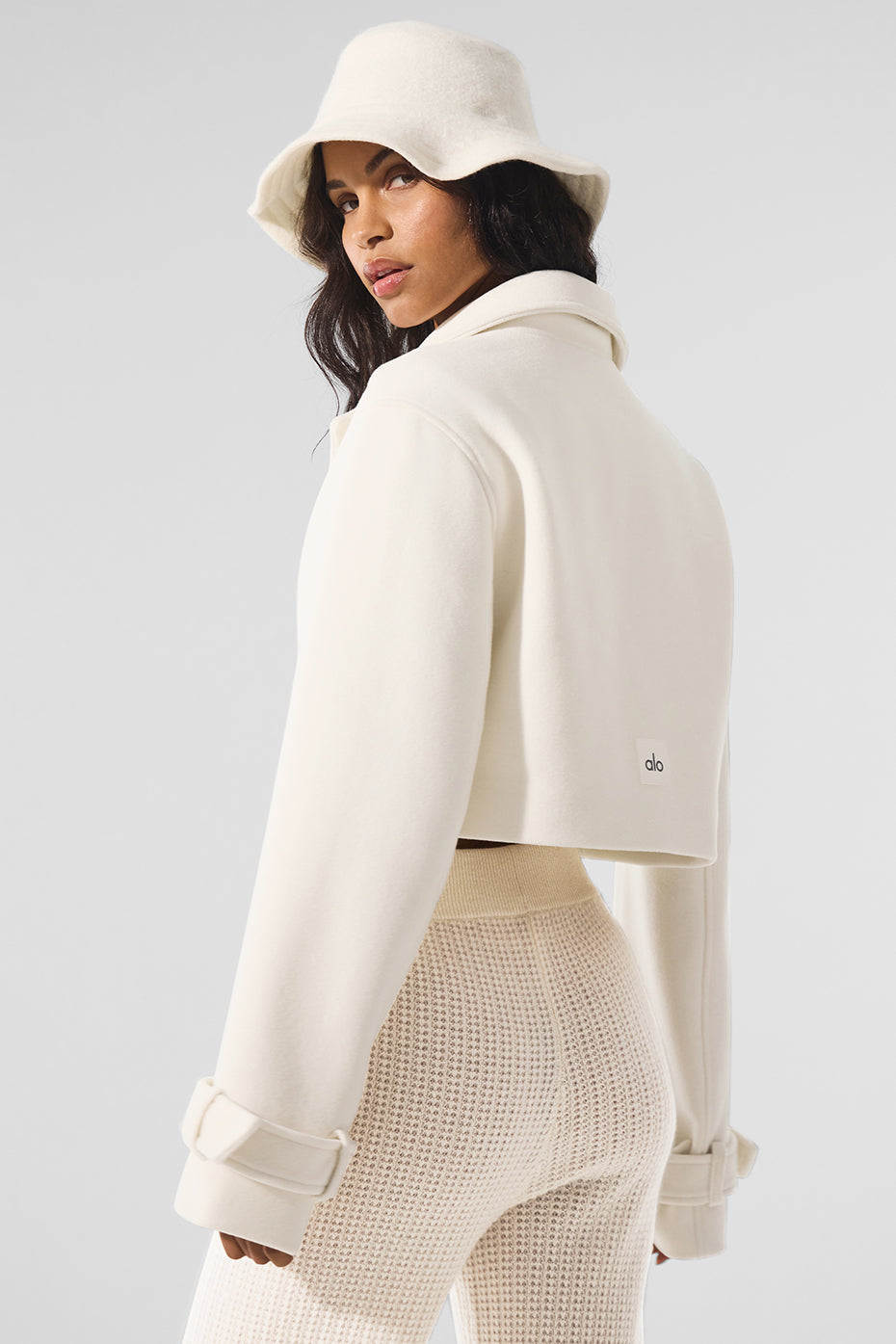 Back view of the ivory trench coat showcasing the boxy fit