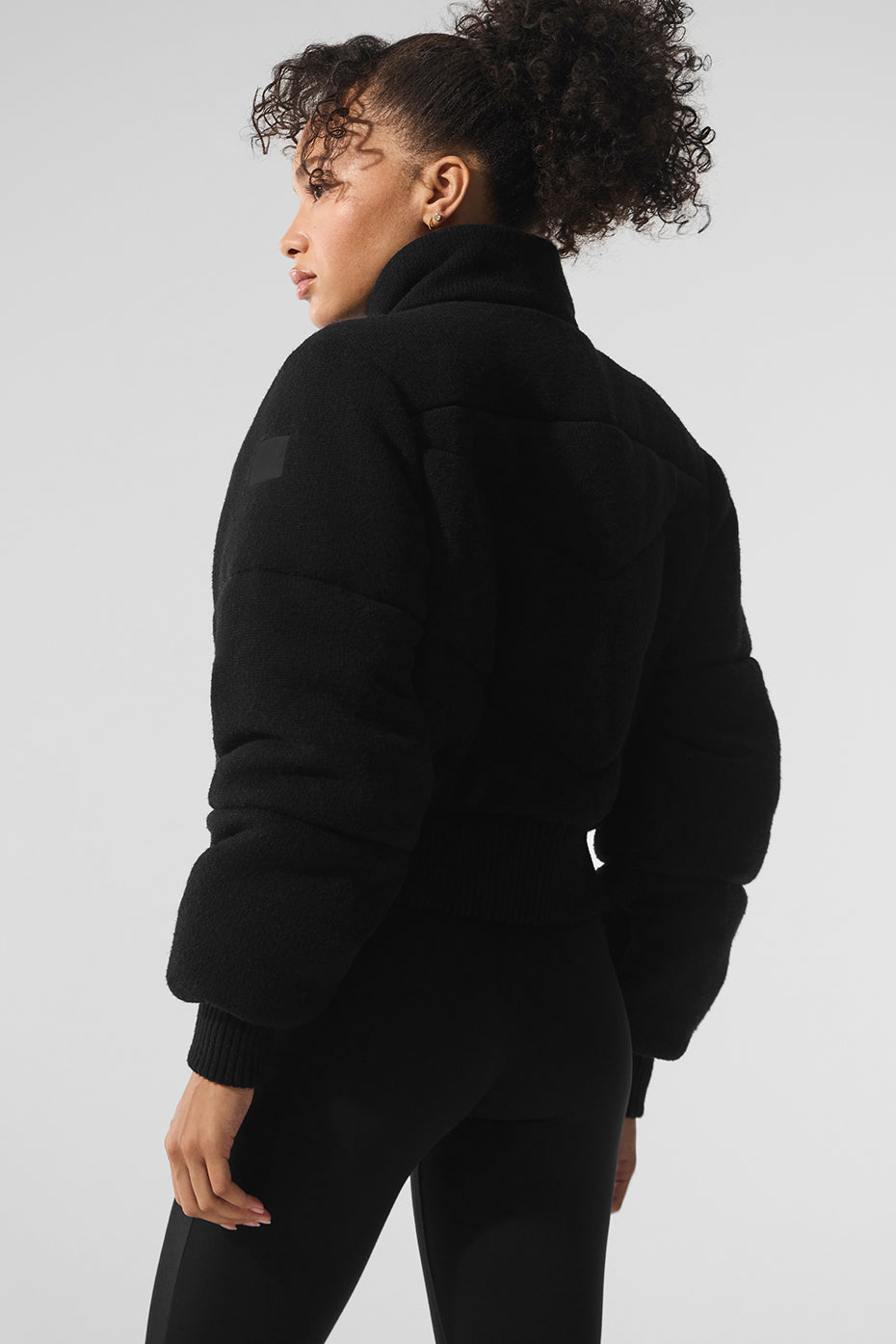 Model wearing the puffer coat in an urban winter setting