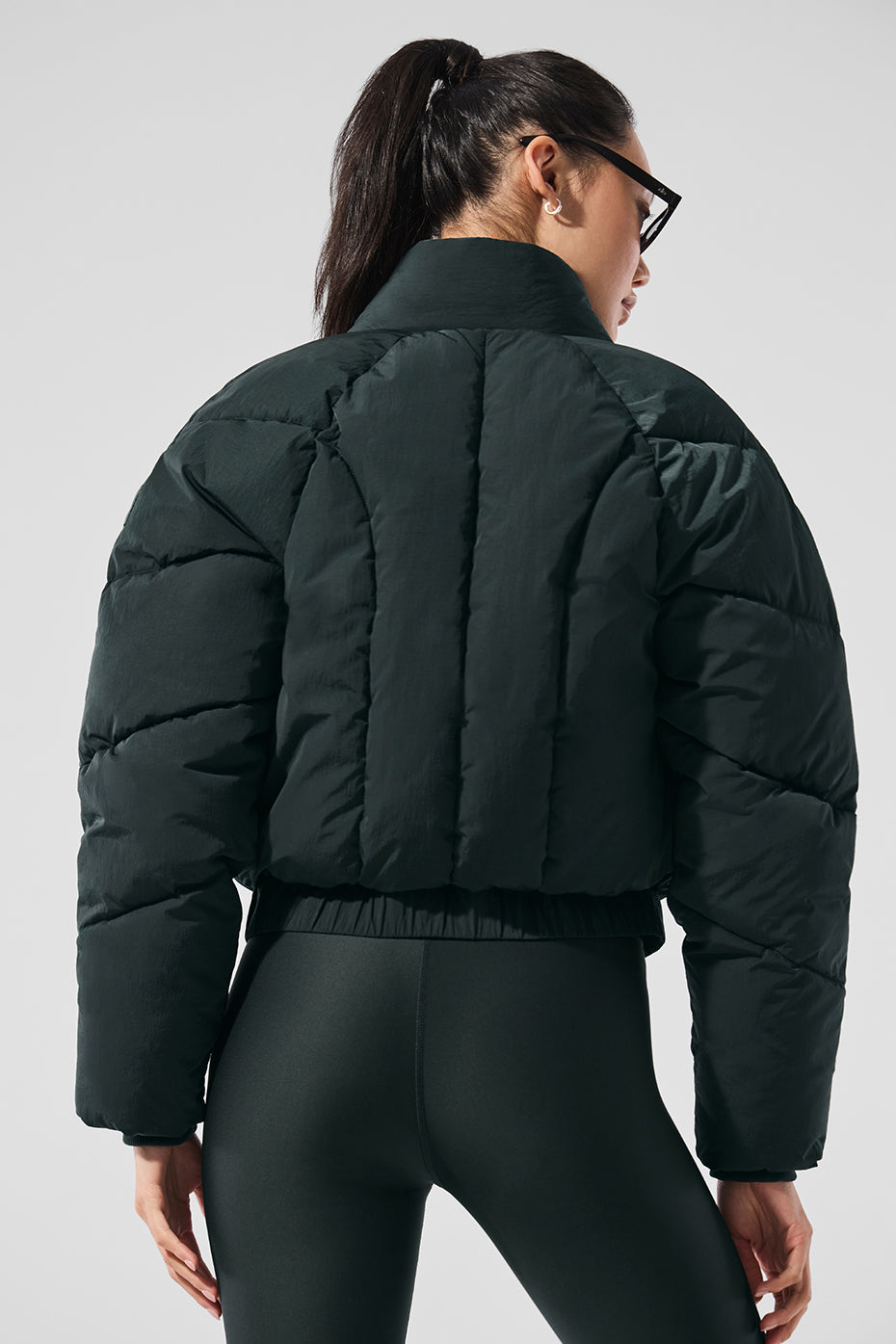 Front view of the charcoal green puffer jacket with belt