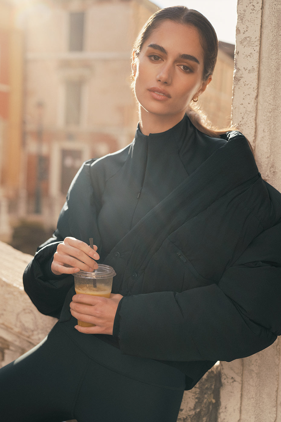 Front view of the charcoal green puffer jacket with belt