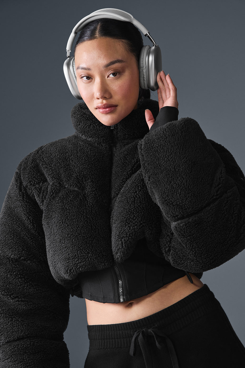 Close-up of sherpa fabric texture and structured puffer silhouette