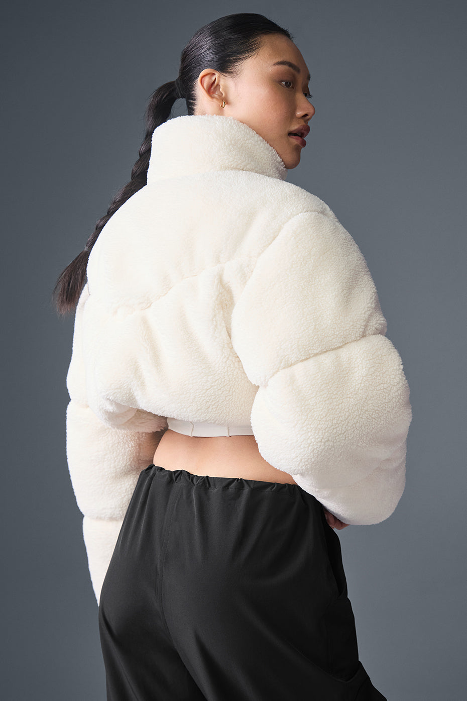 Model showcasing the ivory puffer jacket in a winter setting.
