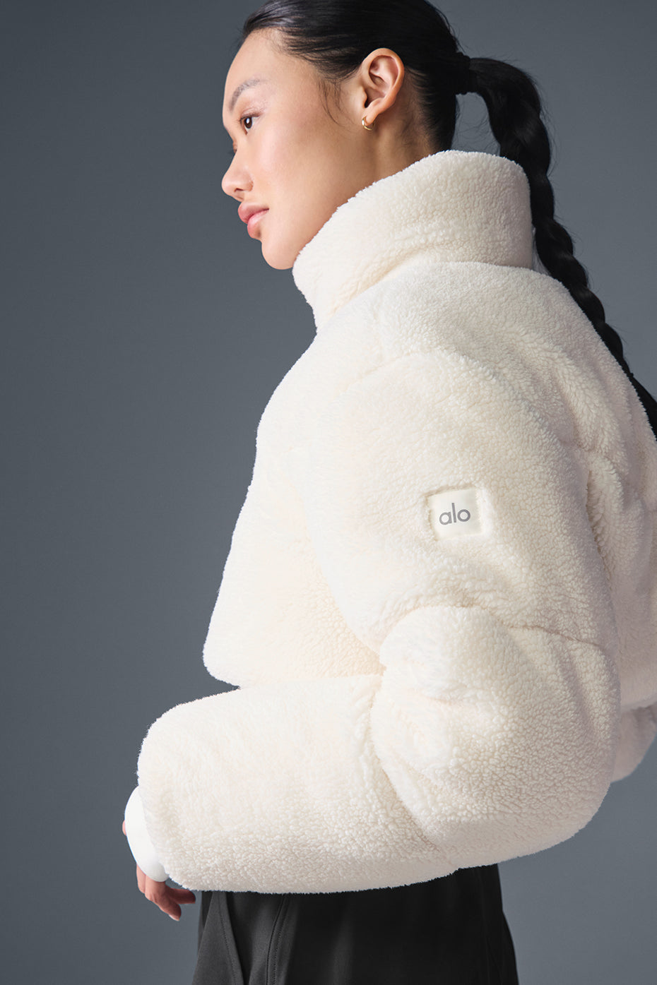 Front view of the ivory sherpa coat women wearing it outdoors.