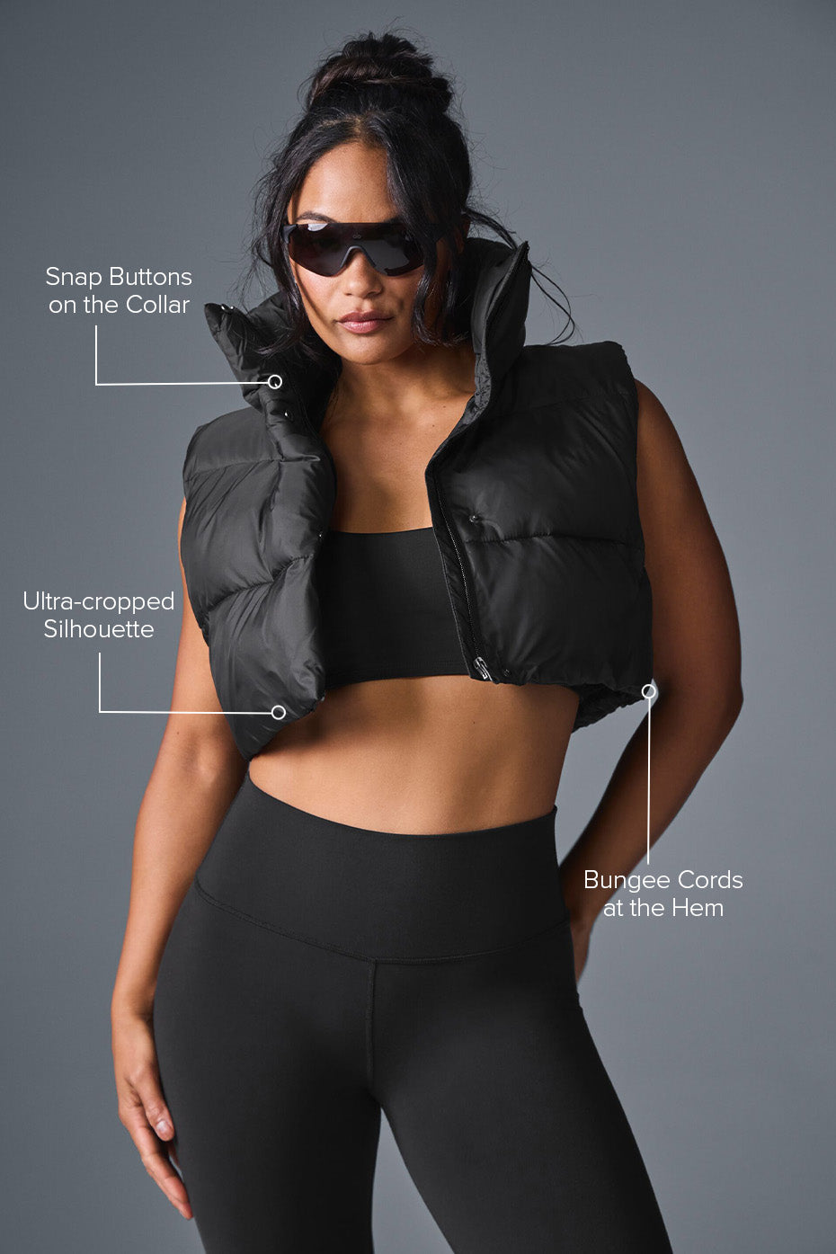 Side angle of mens puffer vest styled with hoodie on city steps