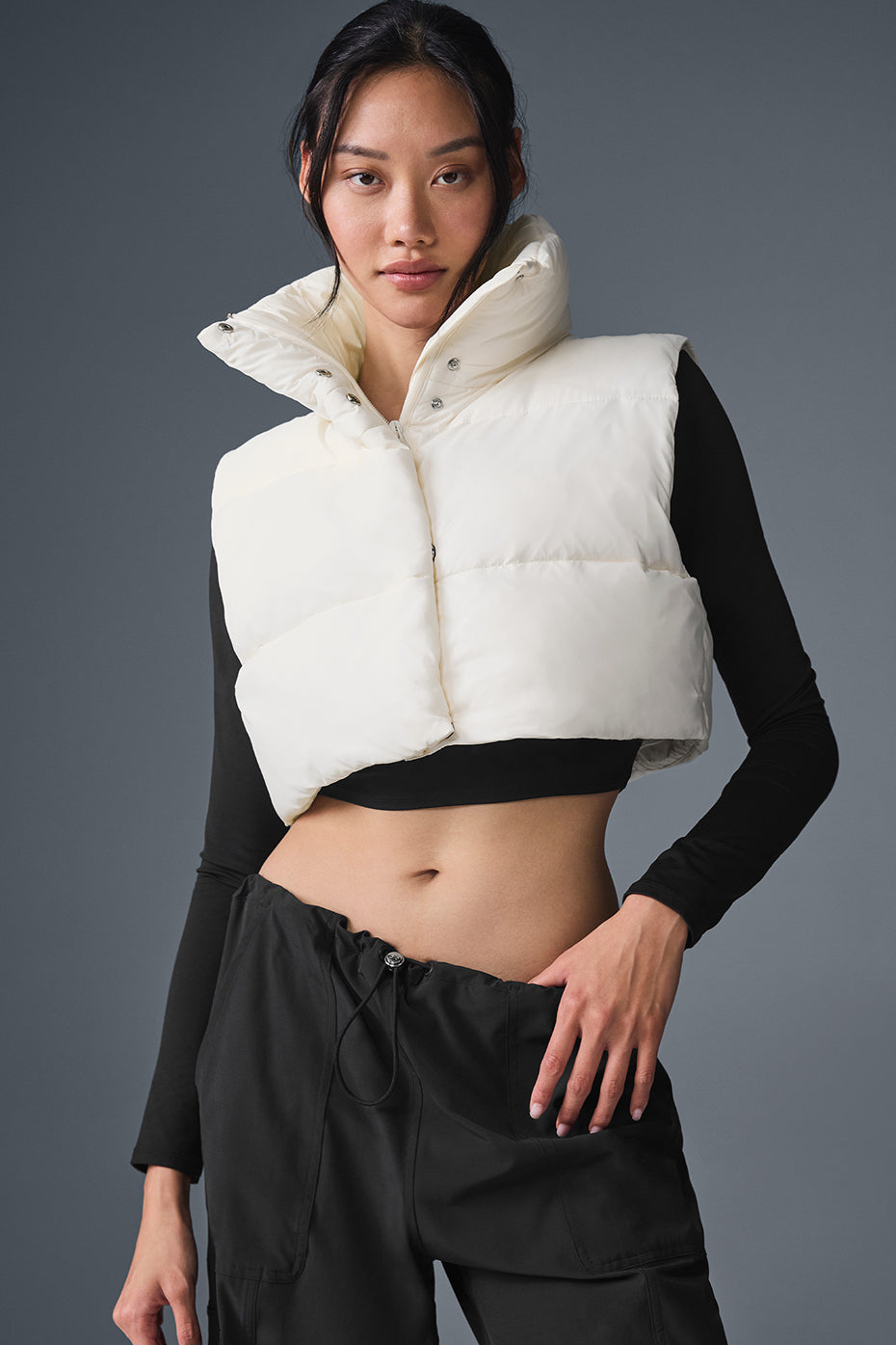 Front view of ivory cropped puffer vest for stylish layering.