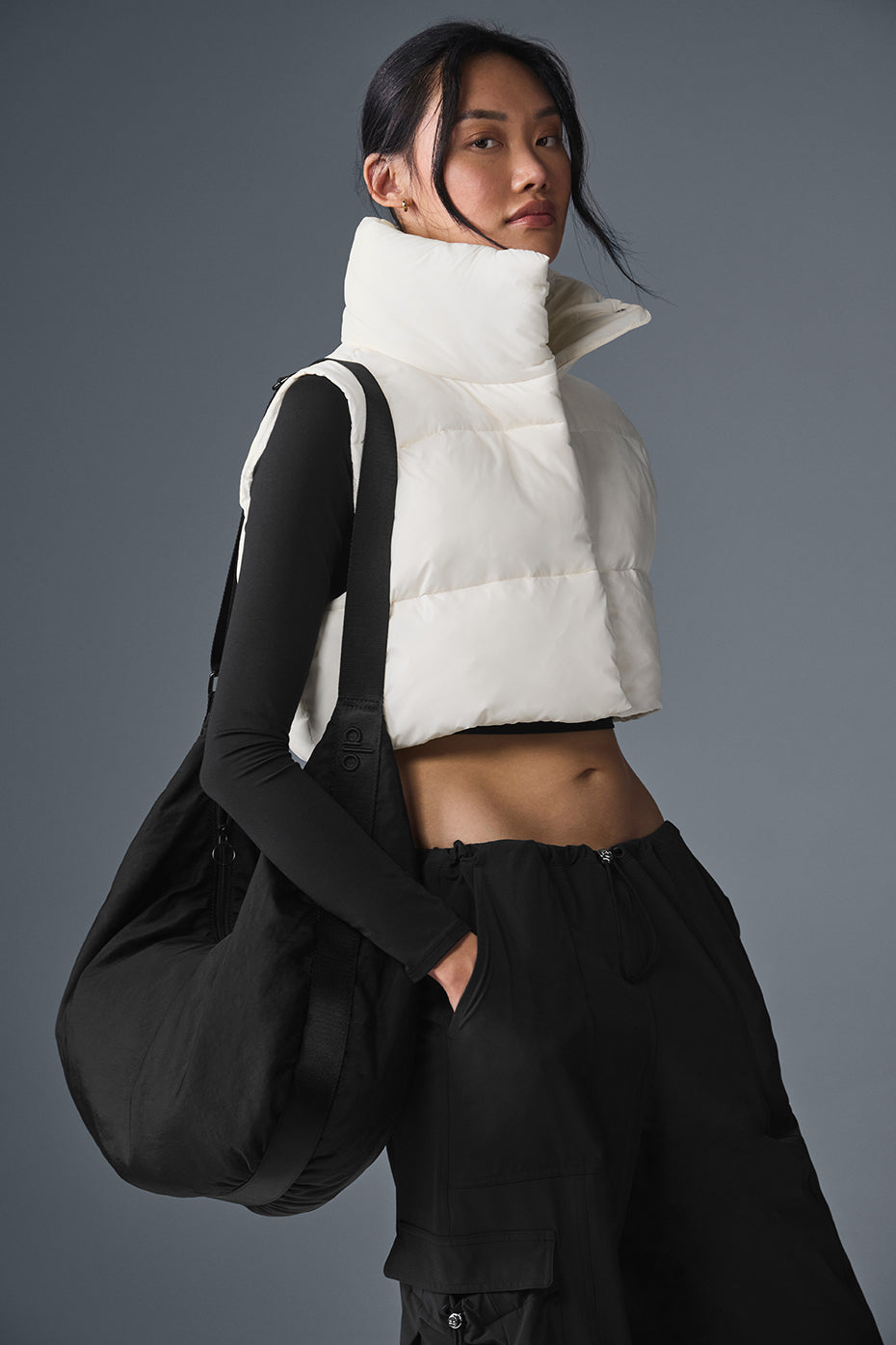 Model wearing cropped puffer vest during a coffee date.