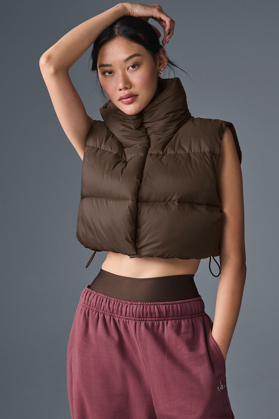 Front view of the cropped puffer vest in espresso color.