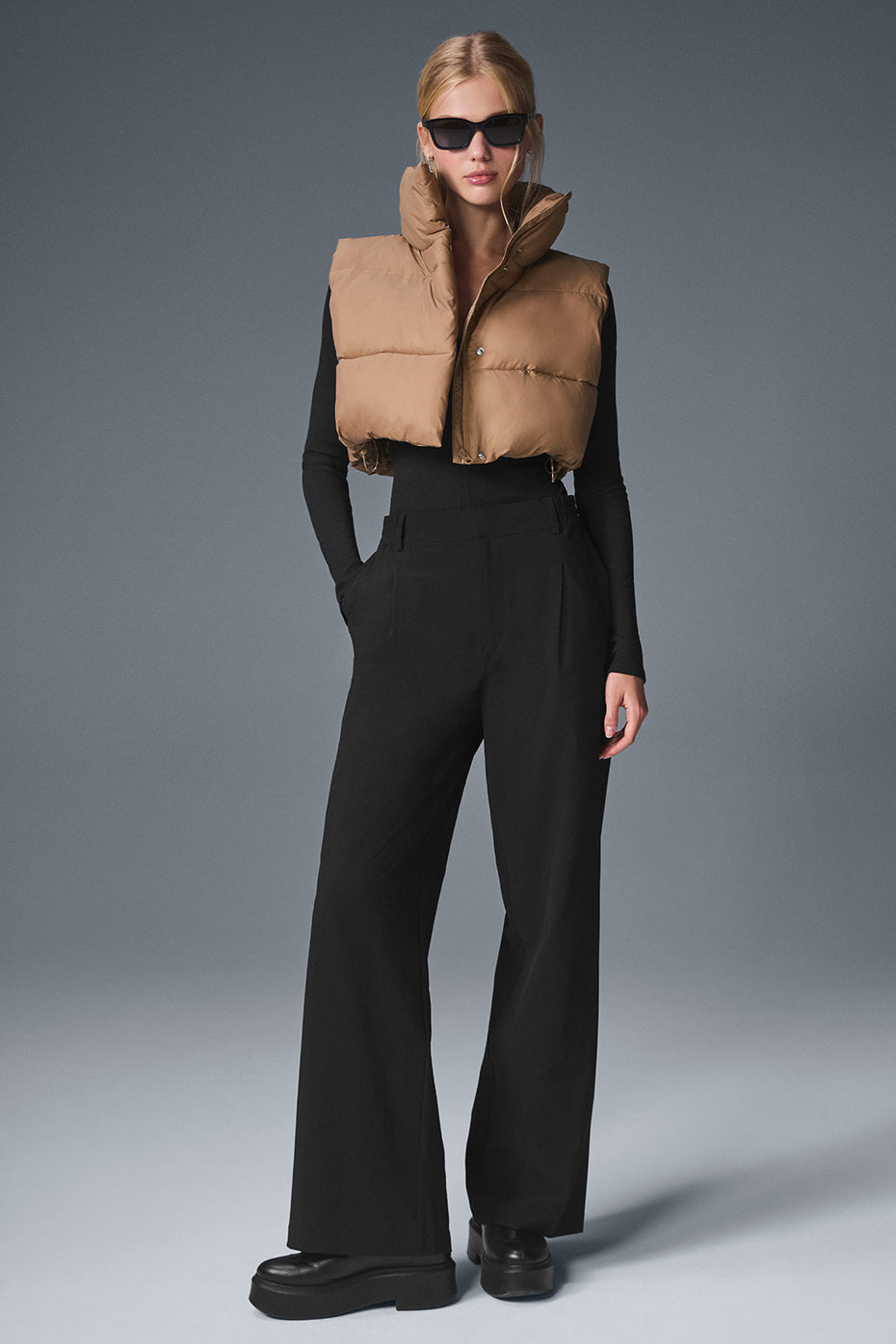 Front view of the cropped gold rush puffer vest in toasted almond.