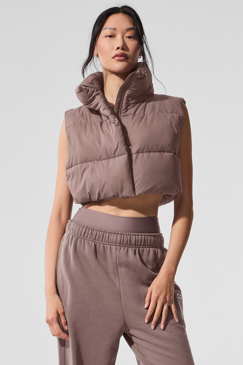 Front view of the chic ultra-cropped gold rush puffer vest in mushroom, ideal for workouts.