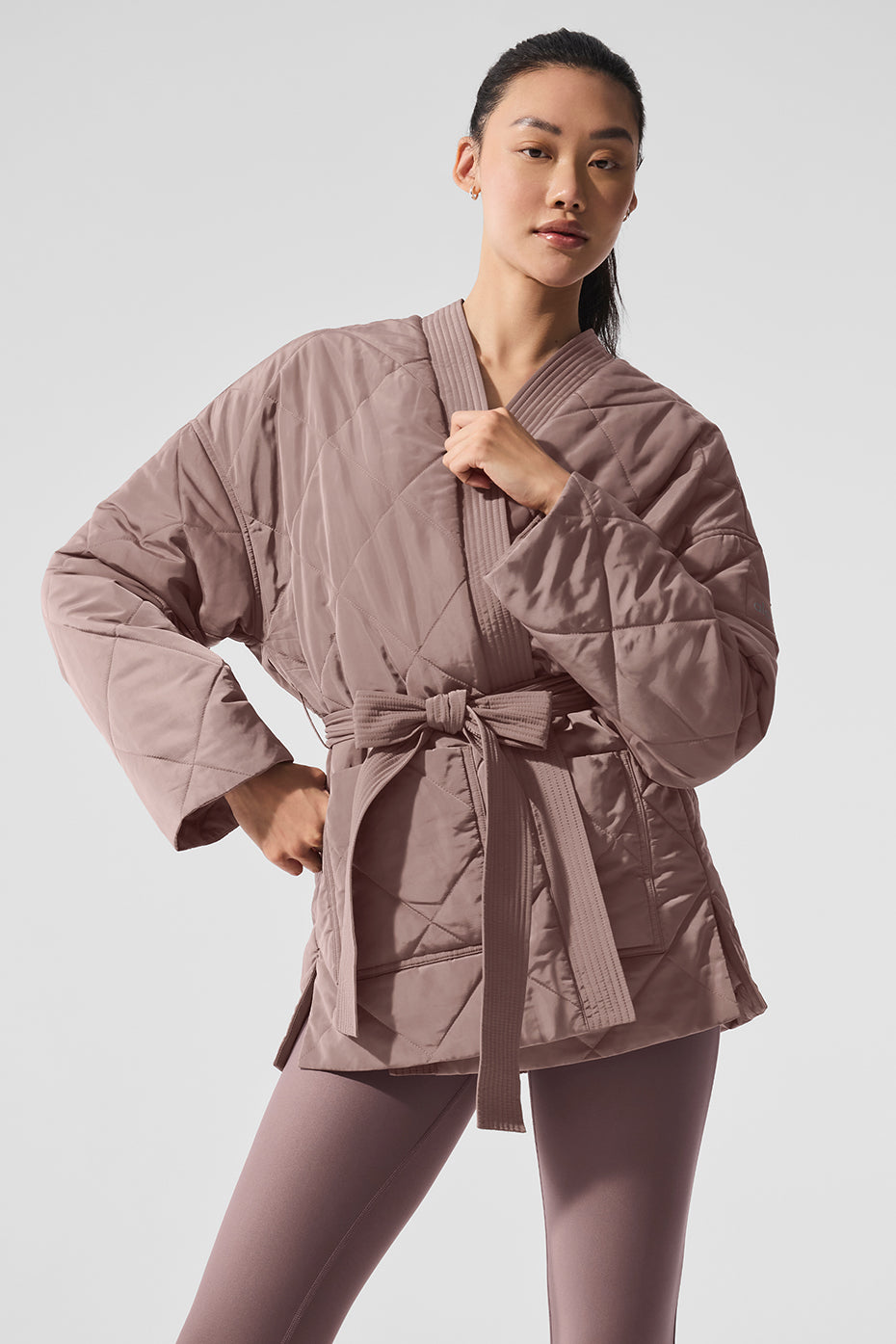 Back view highlighting the drape of the wrap-style puffer