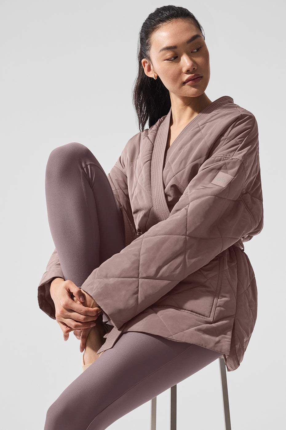 Side view showing the jacket’s streamlined silhouette and pocket details