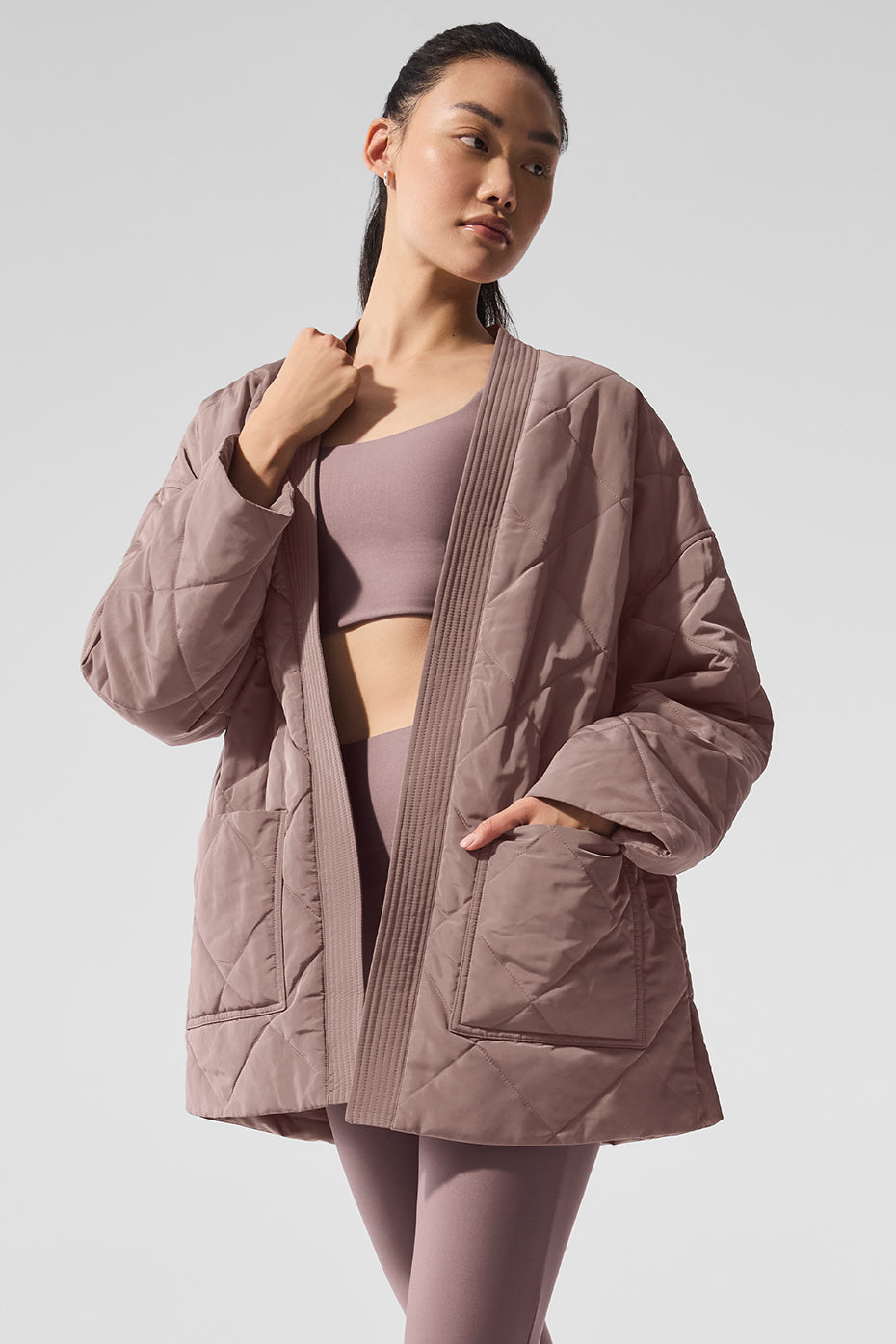 Back view highlighting the drape of the wrap-style puffer