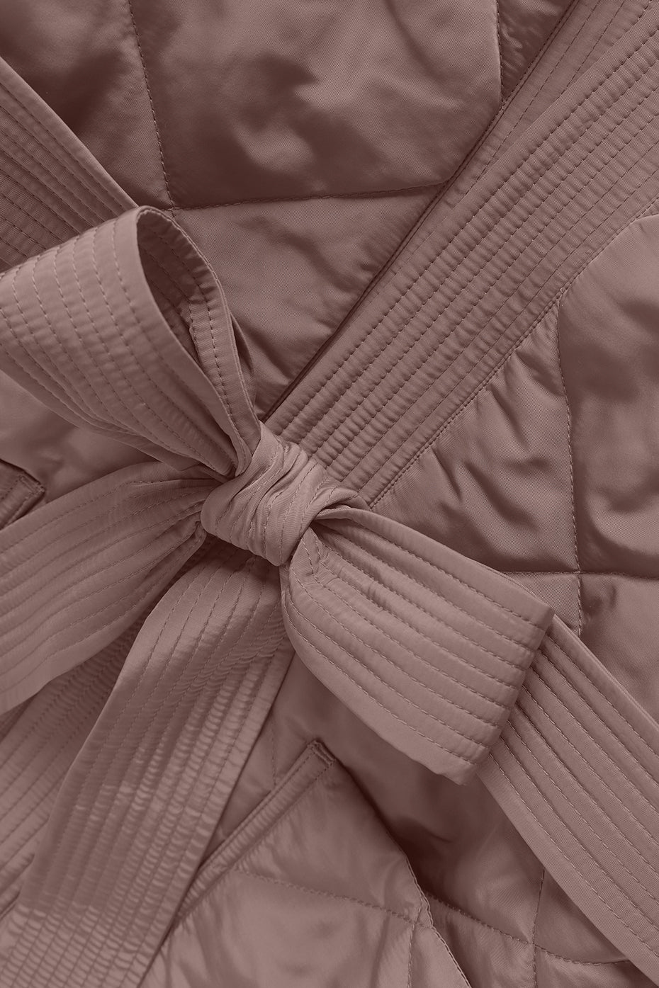 Close-up of the quilted stitching and wrap design on the puffer jacket
