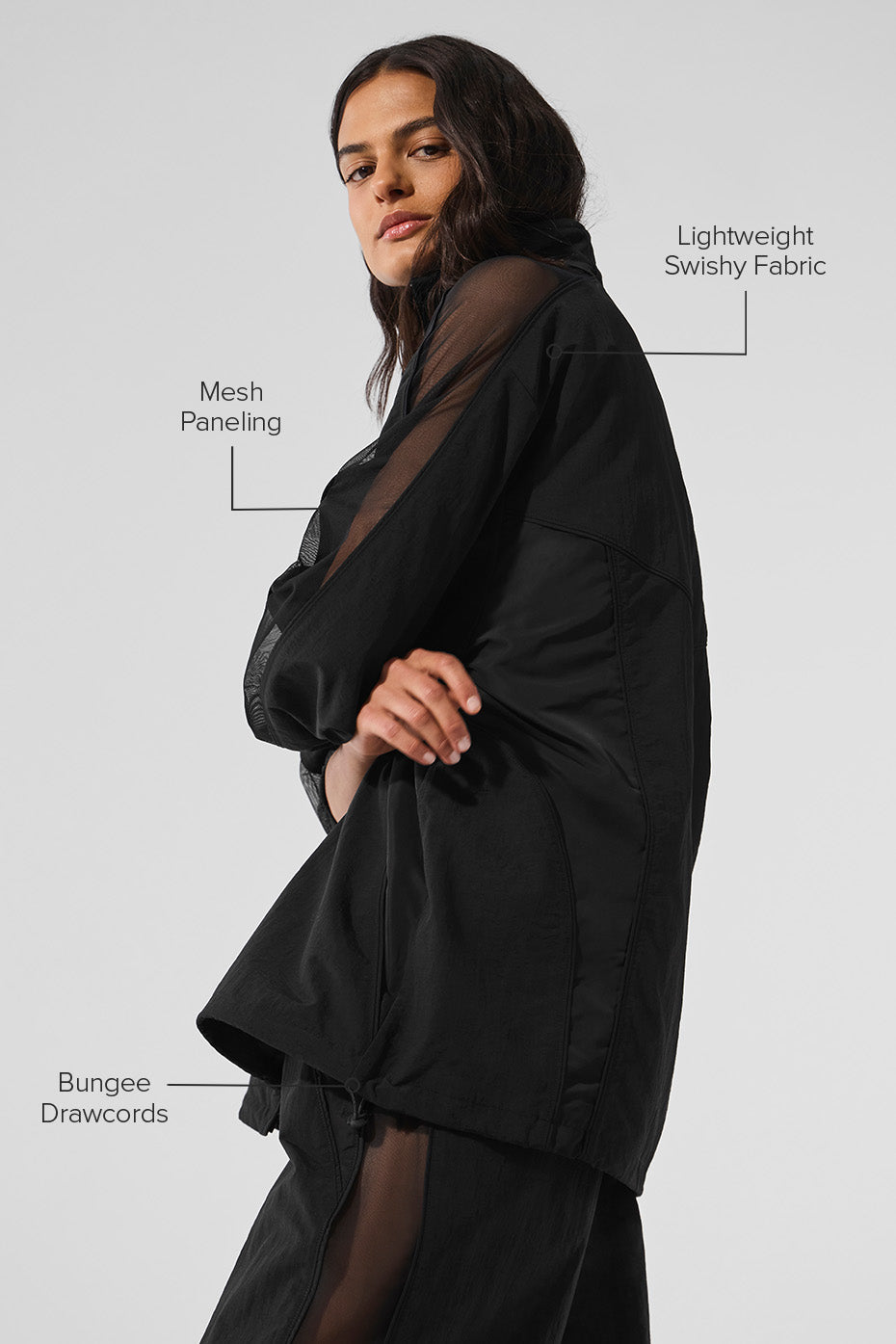 Model wearing mens black track jacket with urban backdrop