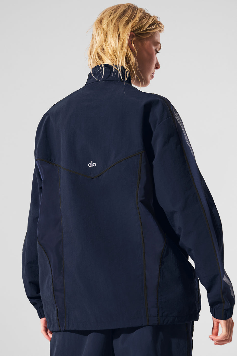 Back view of the fitness jacket, designed for comfort and style.