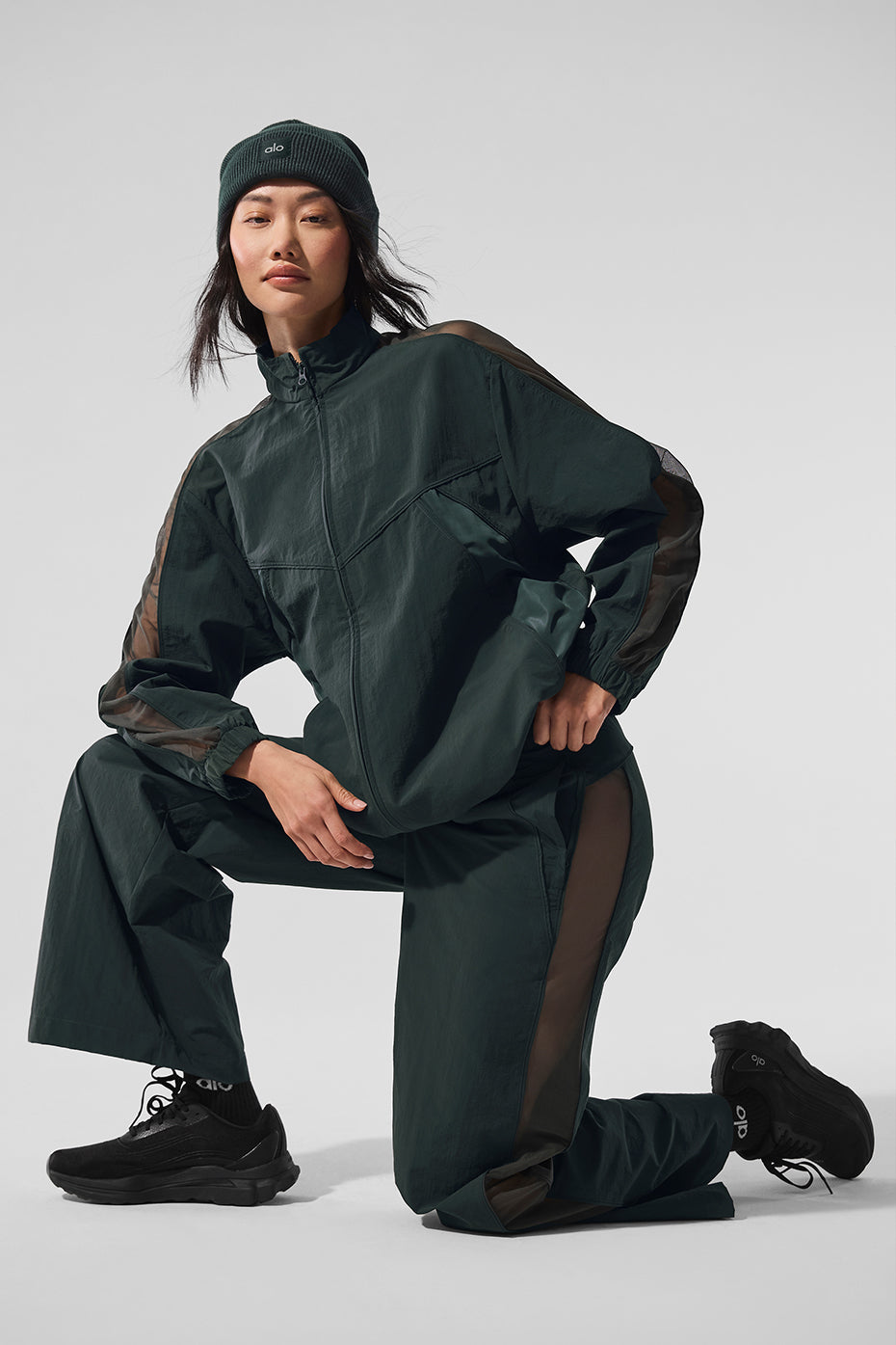 Model wearing the oversized denim jacket with track pants.