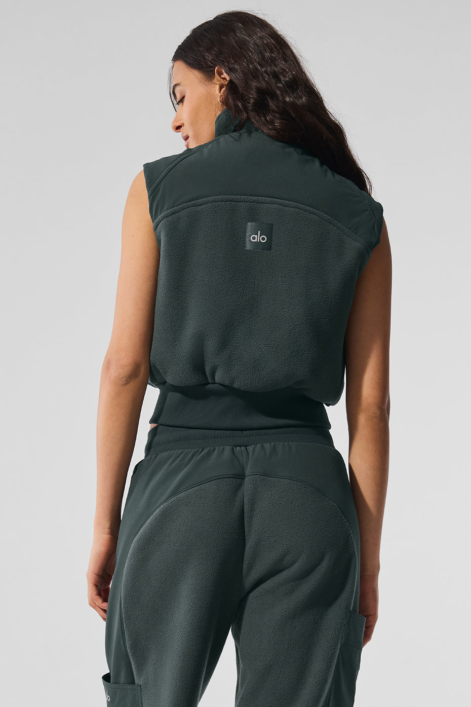 Mens fleece vest layering under a denim jacket for outdoor comfort.