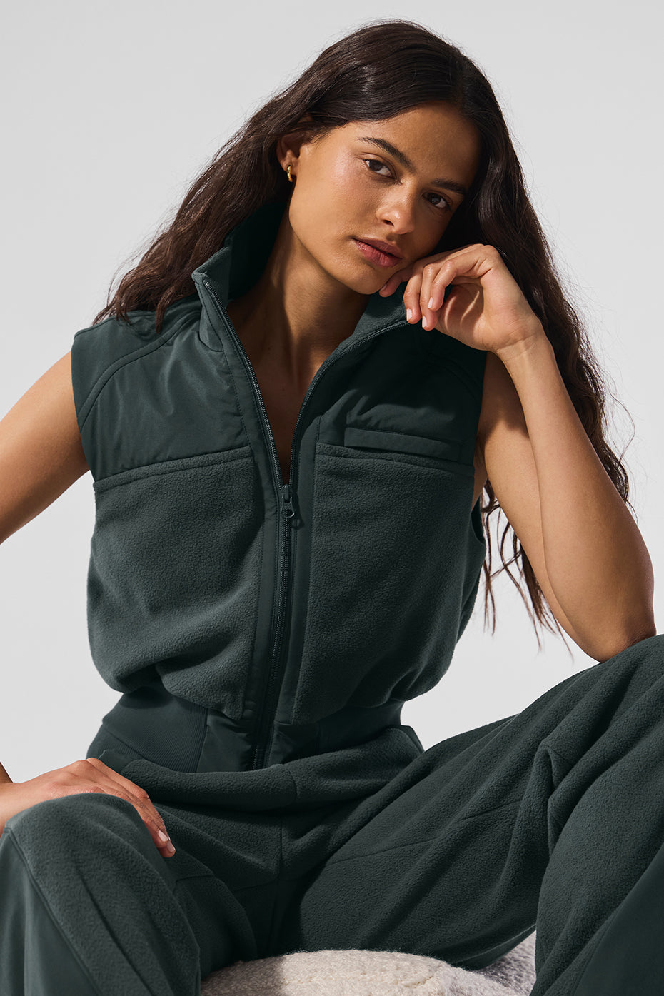 Stylish charcoal green fleece vest paired with winter accessories.