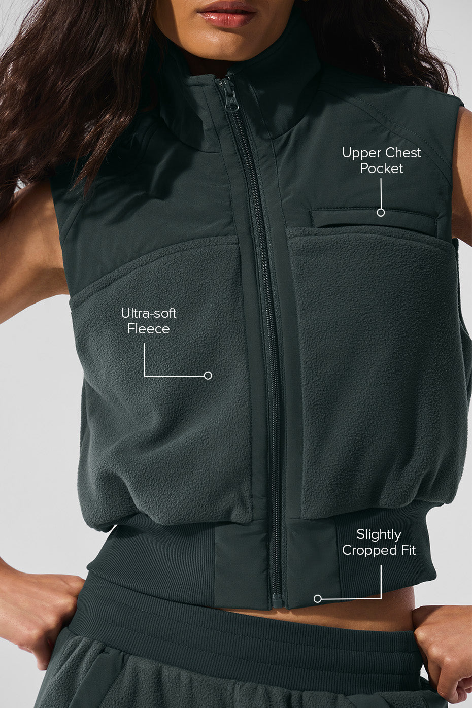 Stylish charcoal green fleece vest paired with winter accessories.
