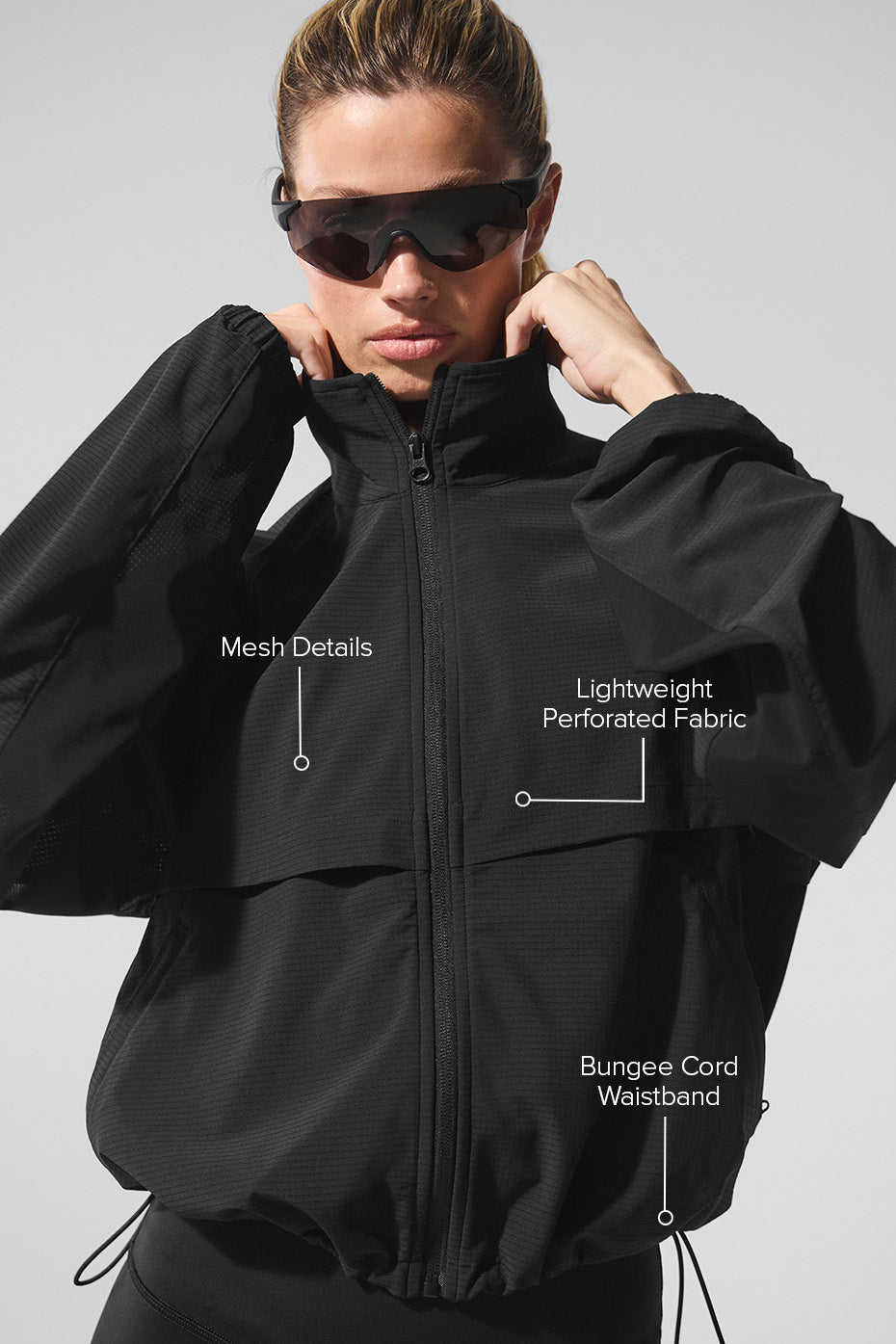 Close-up of perforated fabric detail on the athletic jacket for women