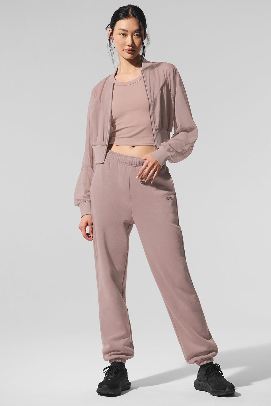 Side angle showing mesh workout jacket over sportswear