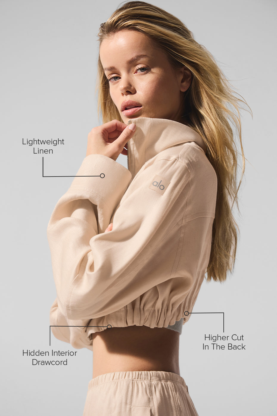 Side angle of the linen cropped jacket, highlighting the asymmetrical hem.