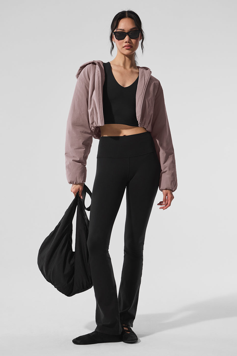 Model wearing cropped zip hoodie on a cool day outdoors