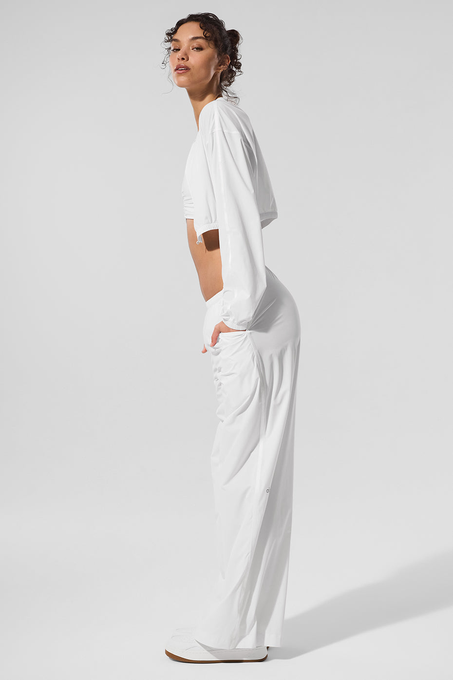 Close-up of the zip detail on the white cover-up jacket for women.