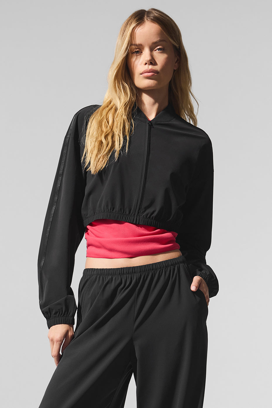 Front view of the cropped full-zip jacket in black, showcasing its stylish design.