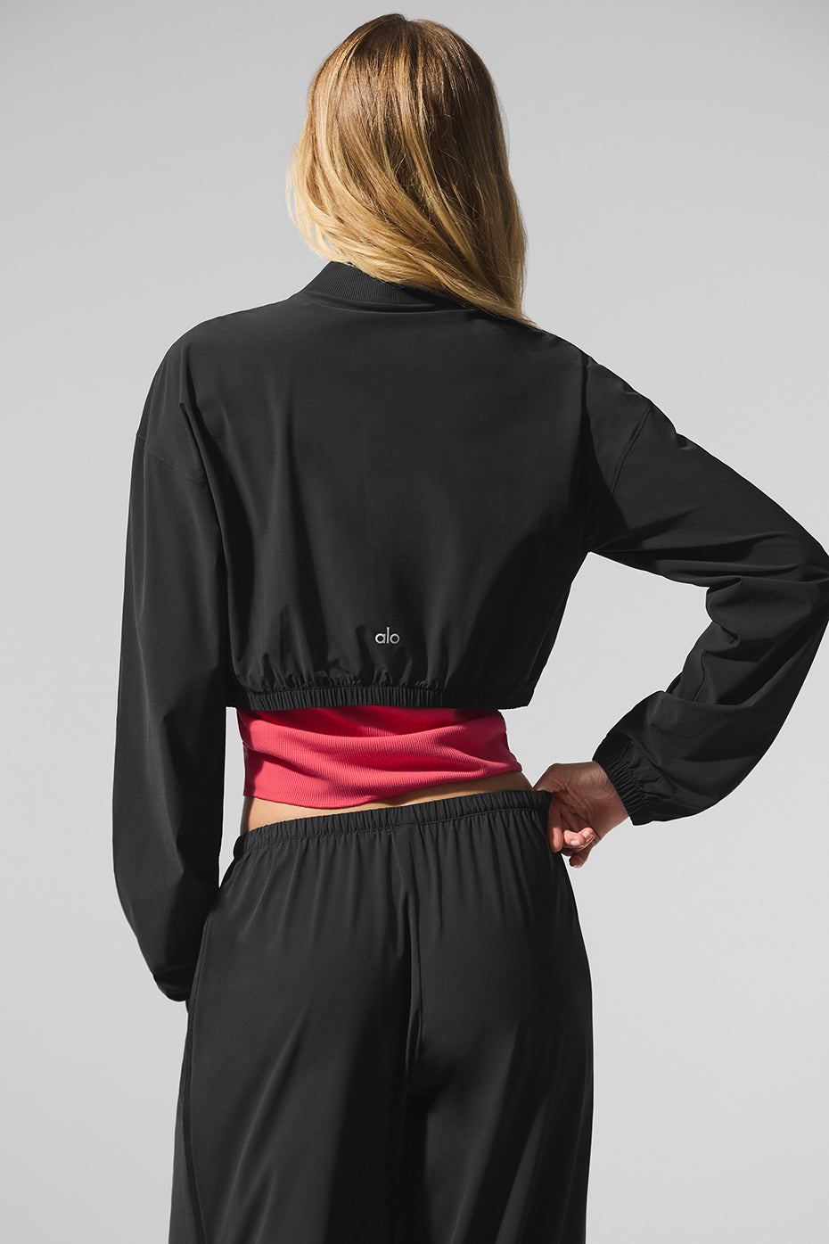 Back view of the cropped jacket, highlighting its comfortable fit and waist-grazing silhouette.