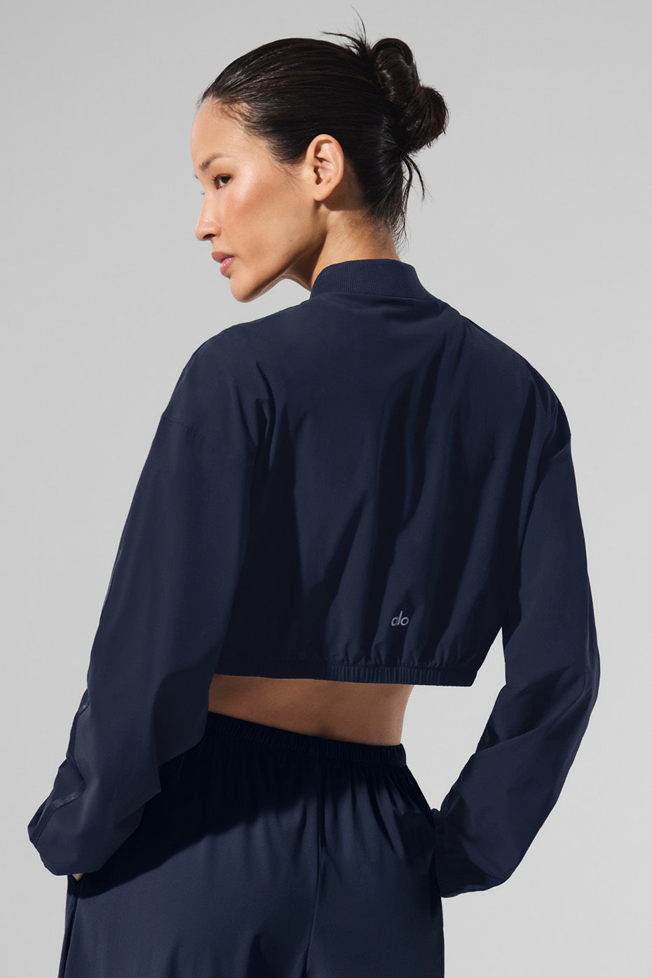 Close-up of full zip detail on cropped bomber jacket