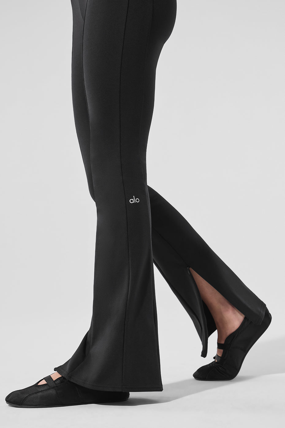 Front view of high-waist flare leggings with zippers in black for a sleek look