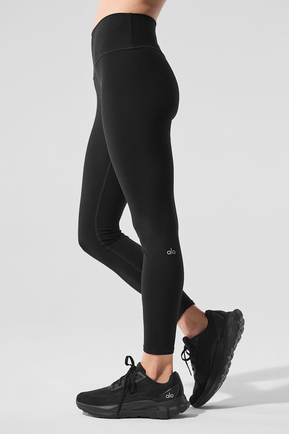 Model wearing Alo Yoga Luxe High-Waist Leggings during a yoga session.