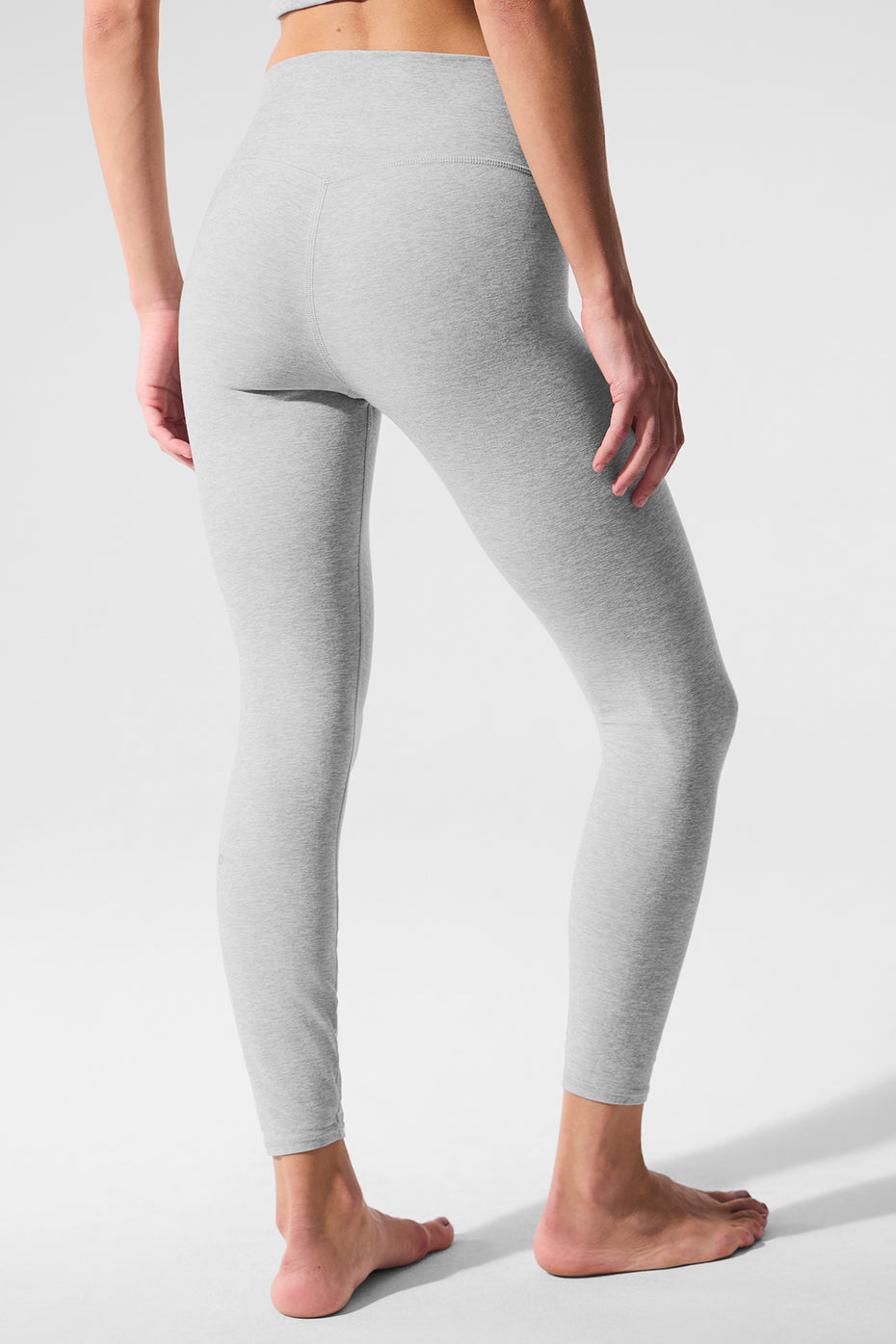 Side view of high waisted leggings, highlighting the contouring back seam and fit.