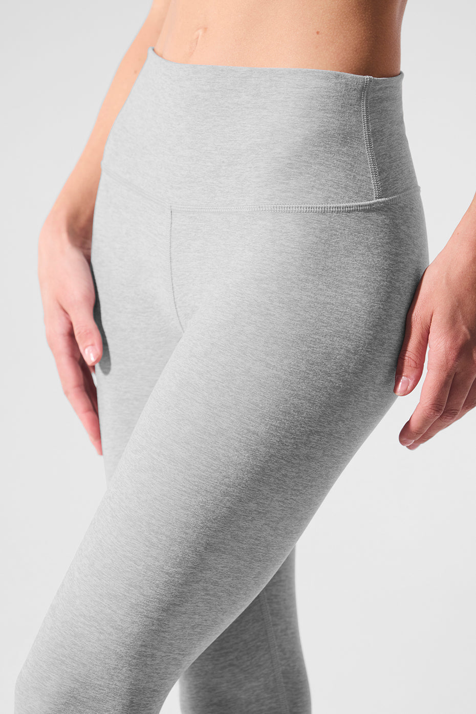 Model wearing Alo Soft High-Waisted Yoga Leggings during a yoga session, demonstrating flexibility.