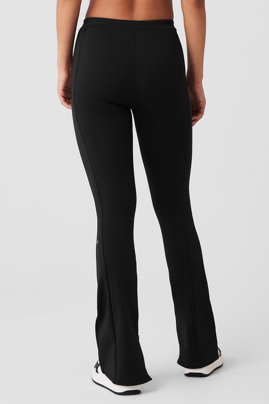 Side view showcasing adjustable flare of black leggings