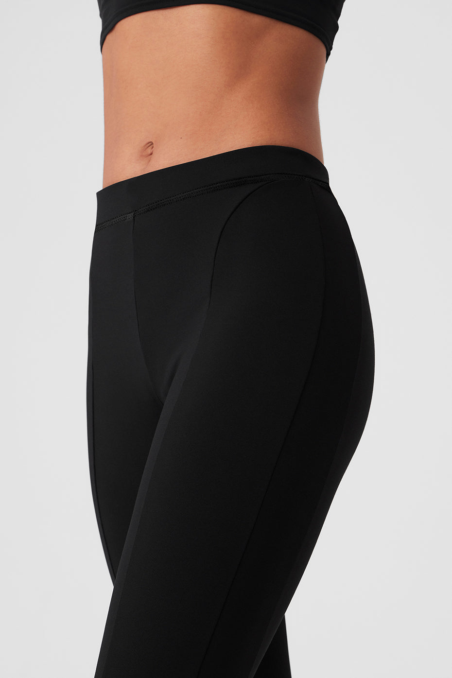Front view of black high-waist flare leggings with zippers