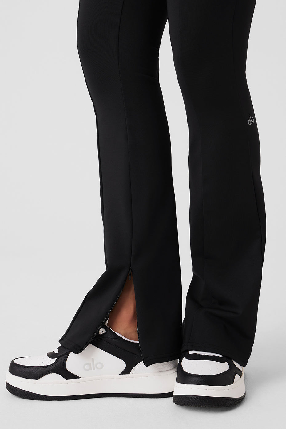 Side view showcasing adjustable flare of black leggings