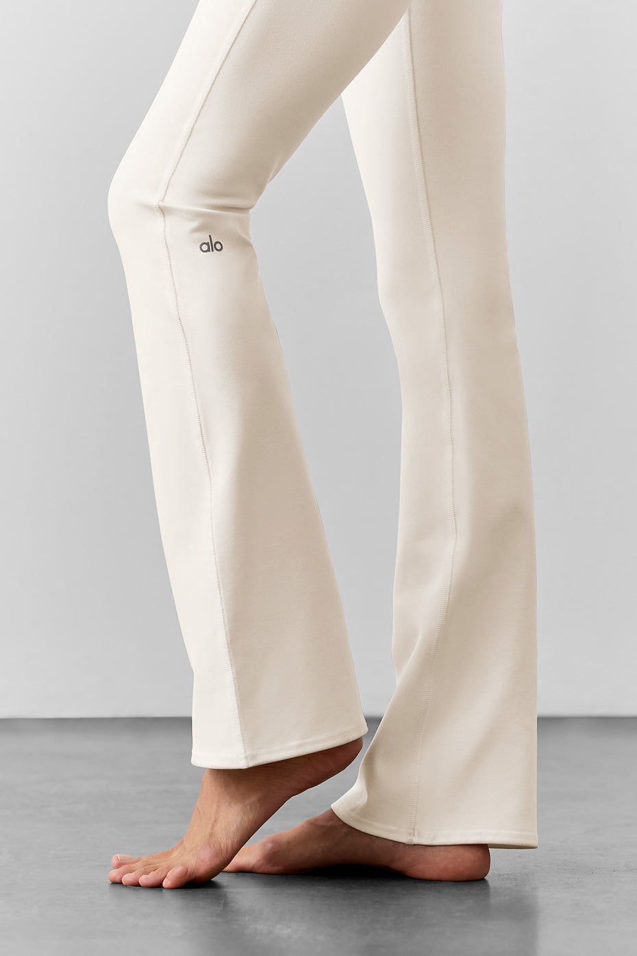 Close-up of ivory high waist bootcut leggings showcasing waistband.