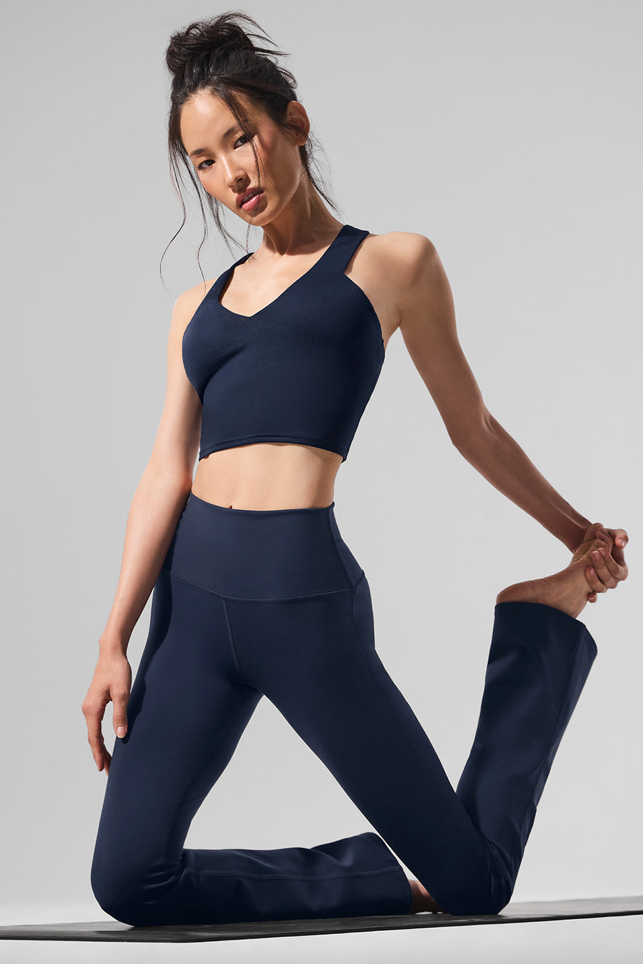 Side view of bootcut yoga leggings showing pockets and wide waistband.