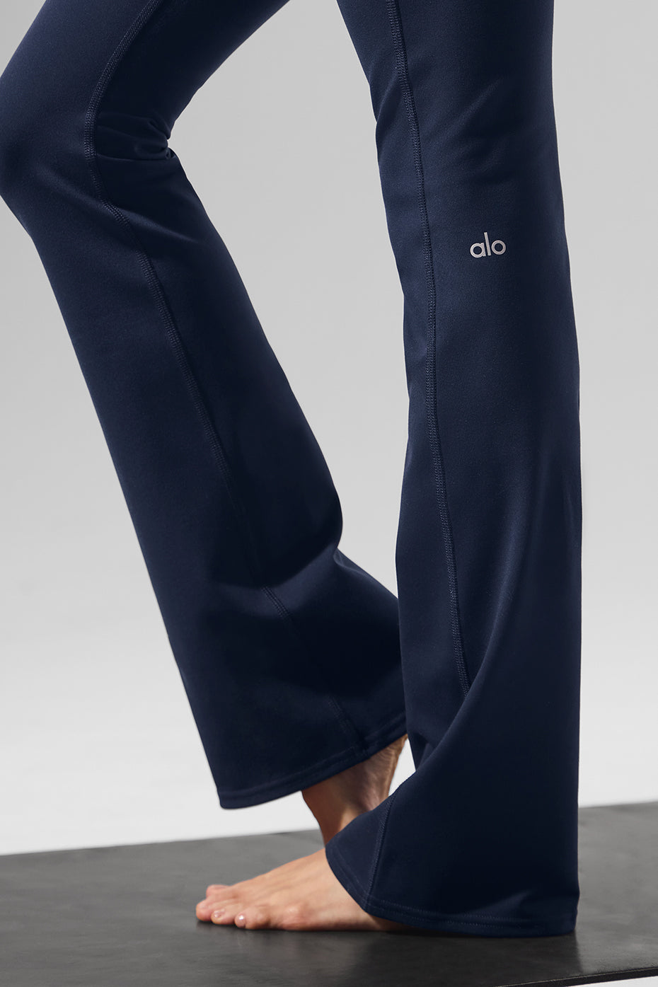 Back view of sculpting high-waist yoga leggings in navy.