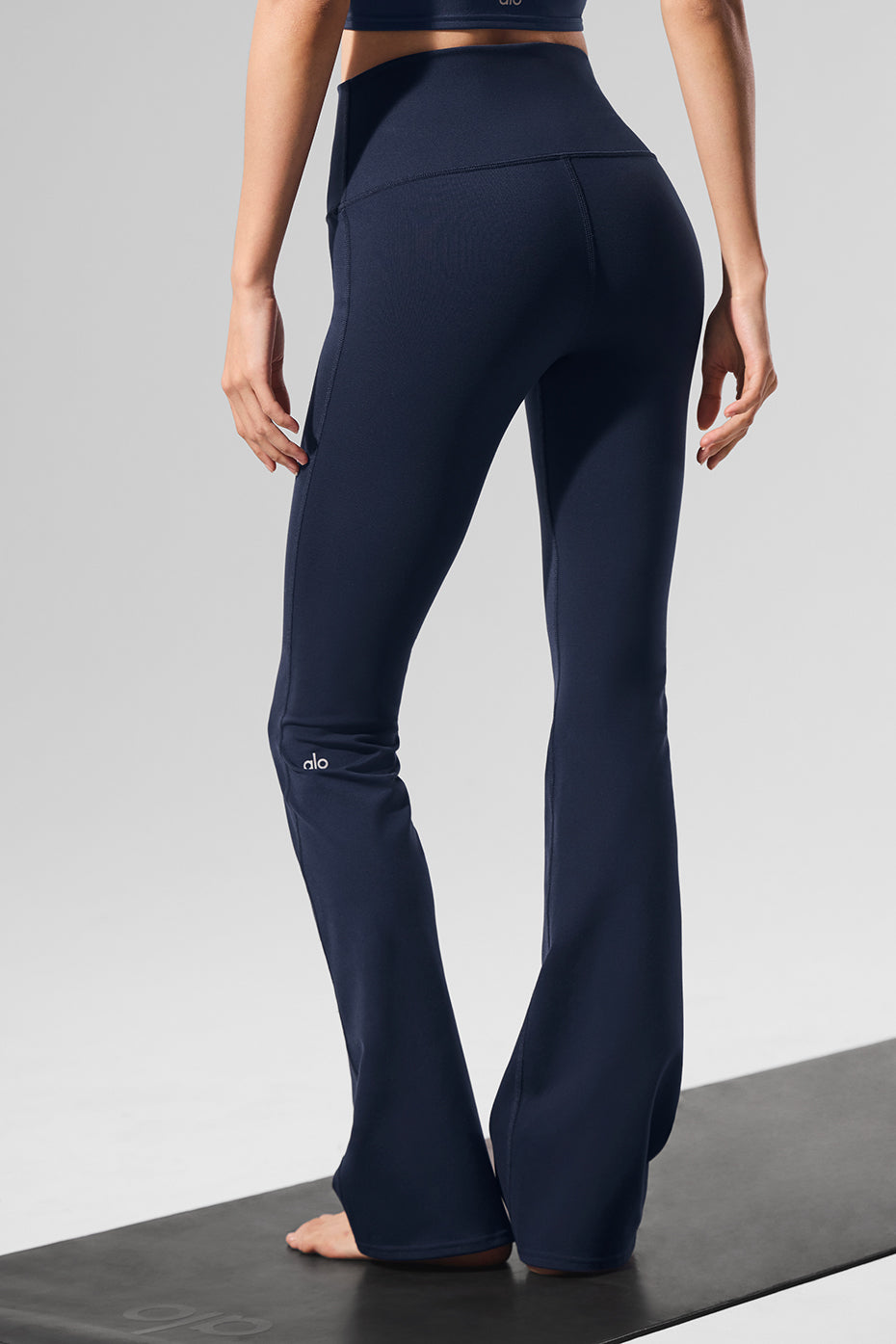 Back view of sculpting high-waist yoga leggings in navy.