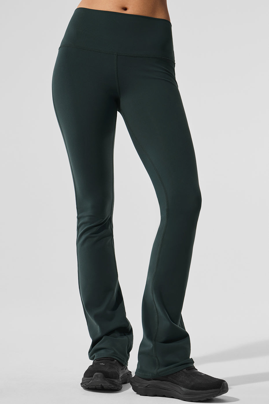 Front angle of high-waist bootcut leggings on model walking through Santa Monica streets