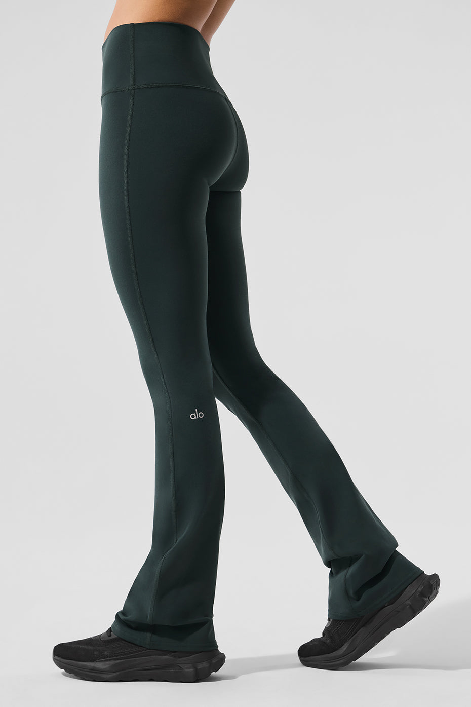 Detail shot showing wide waistband and bootcut leg fit in performance airbrush fabric