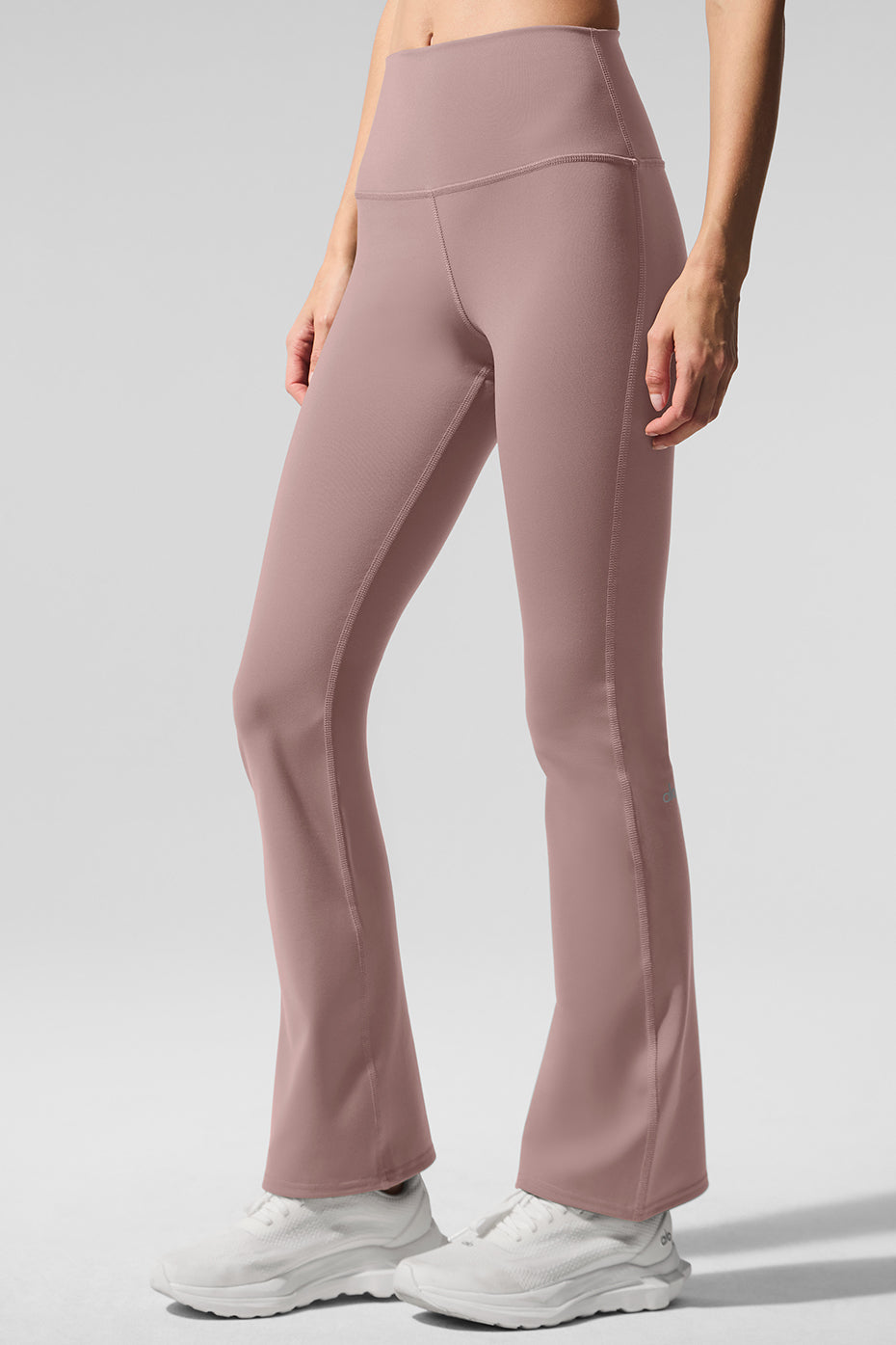 Side angle of leggings, highlighting the sculpting waistband and tapered fit.
